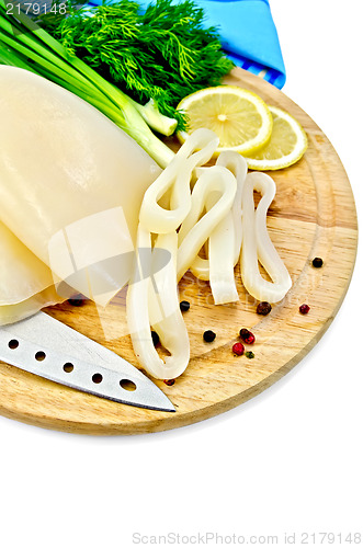 Image of Squid with lemon and knife on a round board