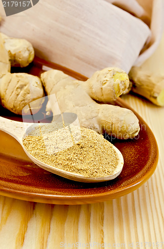 Image of Ginger fresh and dried on a clayware with a napkin