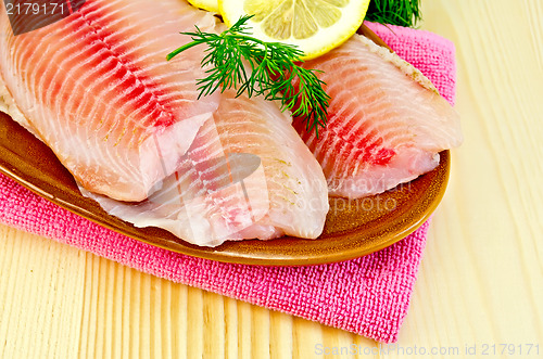 Image of Fillets tilapia in a pottery on a napkin