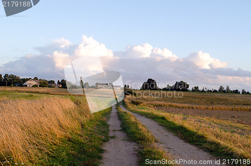 Image of rural gravel road agriculture field farm buildings 