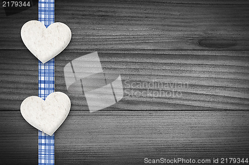 Image of Two hearts laying on wood