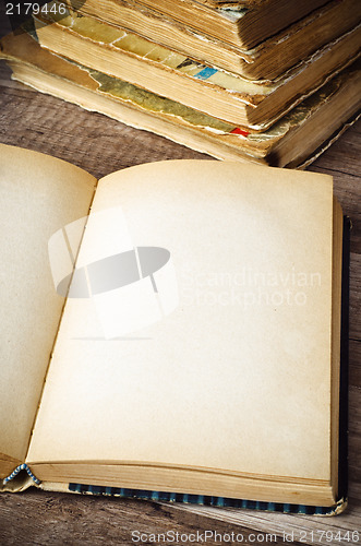 Image of open old book on a wooden surface 