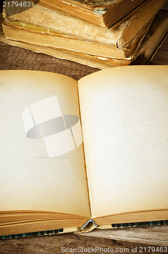 Image of open old book on a wooden surface 