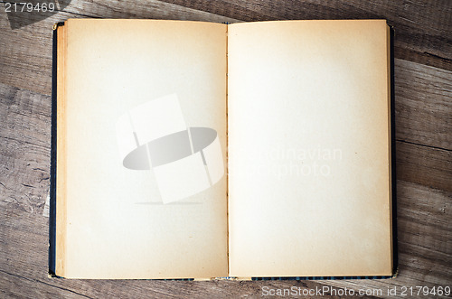 Image of open old book on a wooden surface 