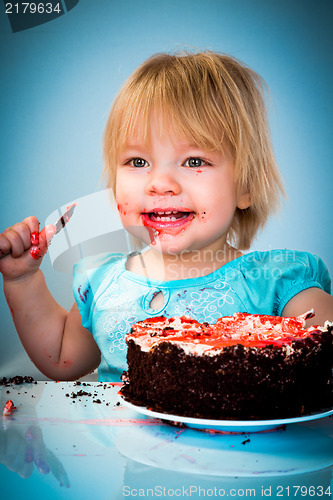 Image of Little baby girl eating cake