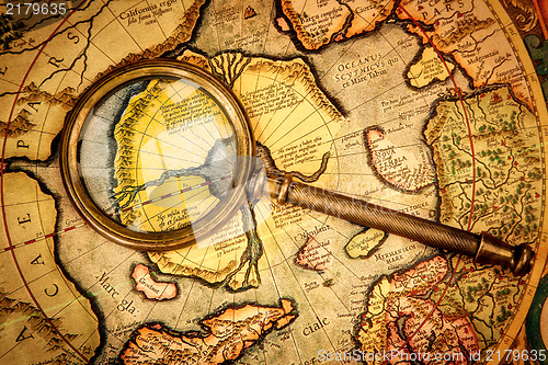 Image of Vintage magnifying glass lies on the ancient map of the North Po