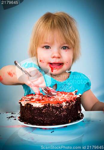 Image of Little baby girl eating cake