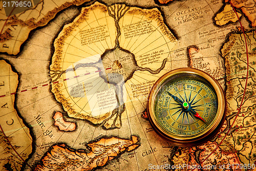 Image of Vintage compass lies on an ancient map of the North Pole.