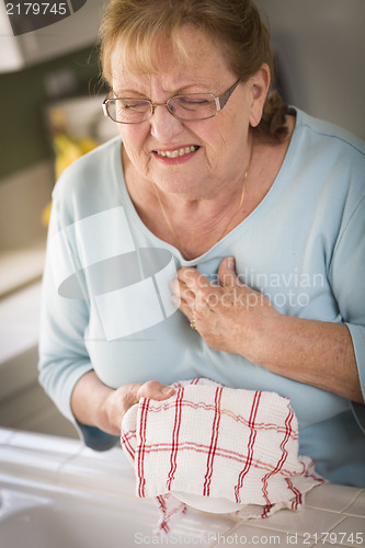 Image of Senior Adult Woman At Sink With Chest Pains