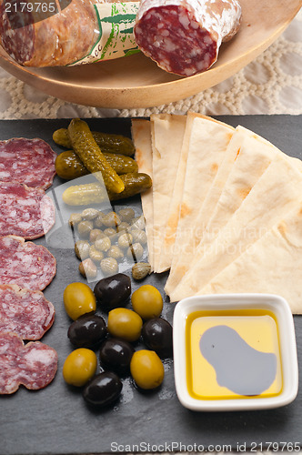 Image of cold cut platter with pita bread and pickles