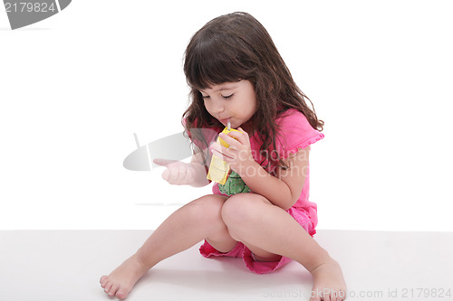 Image of Close-up of beautiful little girl drinking from a juice box. Sho