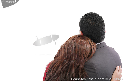 Image of Rear view of a loving couple standing with arms around 