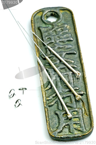 Image of acupuncture needles on chinese coin