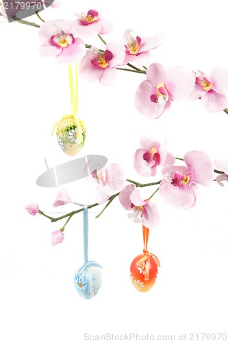 Image of hanged bright color easter eggs with bows on spring flower