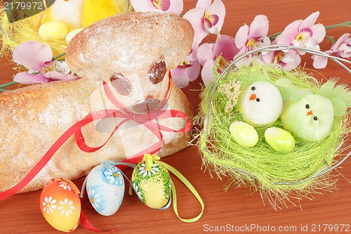 Image of Easter lamb with painted eggs and nest
