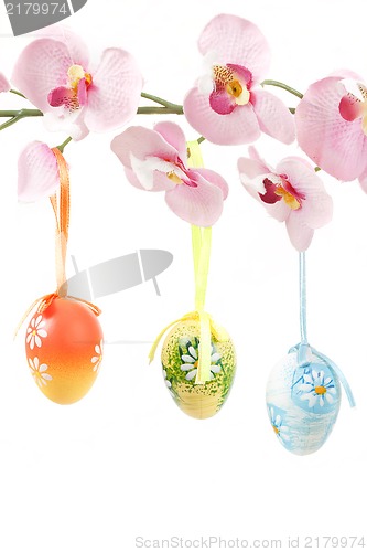 Image of hanged bright color easter eggs with bows on spring flower