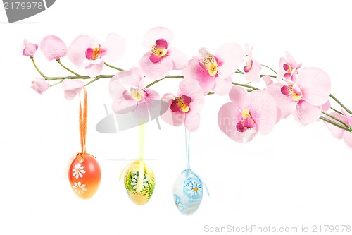 Image of hanged bright color easter eggs with bows on spring flower