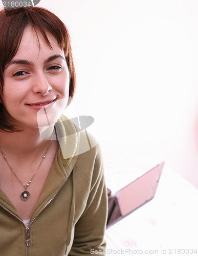 Image of Young woman in bed