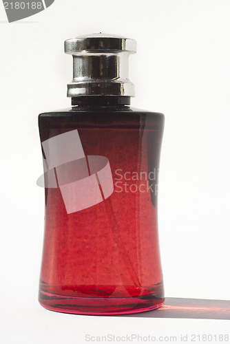 Image of perfume in red bottle