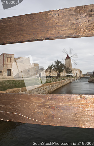 Image of old mill seen from behind the fence