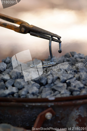 Image of iron smith working near hot coal