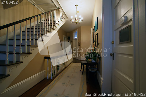 Image of staircase and a hallway inside historic house