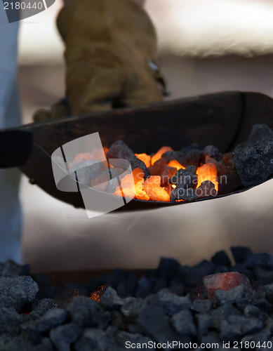 Image of iron smith working near hot coal