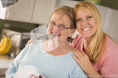 Image of Senior Adult Woman and Young Daughter Portrait in Kitchen