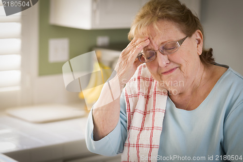 Image of Sad Crying Senior Adult Woman At Kitchen Sink