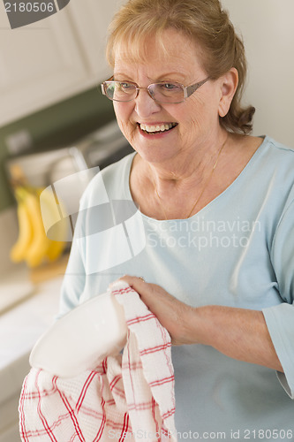 Image of Senior Adult Woman Drying Bowl At Sink in Kitchen