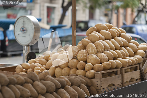 Image of pile of new and old potatoes for sale