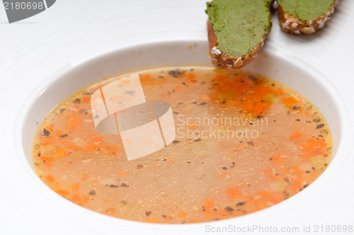 Image of Italian minestrone soup with pesto crostini on side