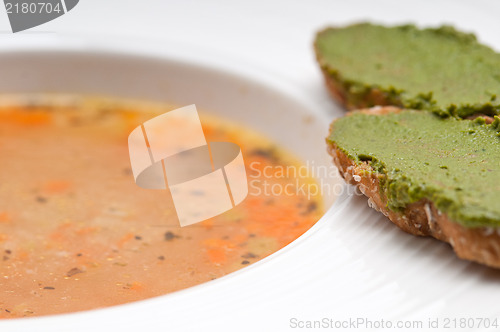 Image of Italian minestrone soup with pesto crostini on side