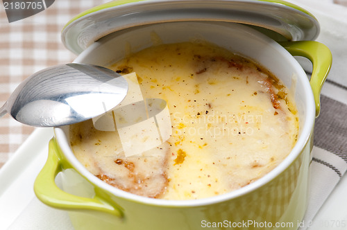 Image of onion soup with melted cheese and bread on top