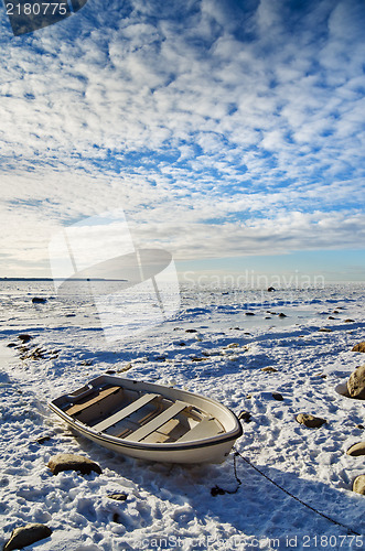 Image of Fishing boat on the sea shore sunny winter afternoon