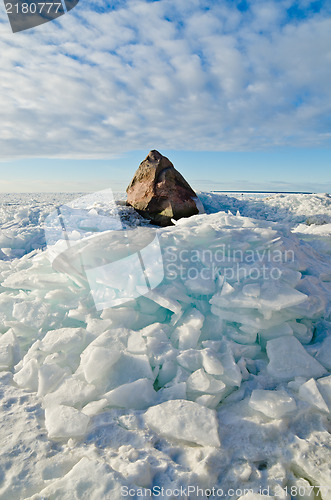 Image of Big stone in the ice on the Baltic Sea coas