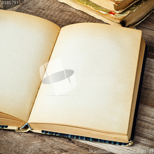 Image of open old book on a wooden surface 