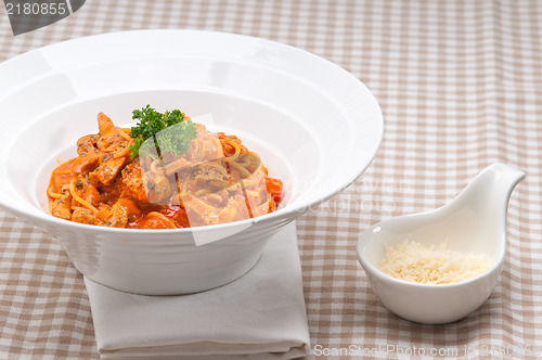 Image of Italian spaghetti pasta with tomato and chicken