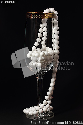 Image of Glass and white necklace on a black 