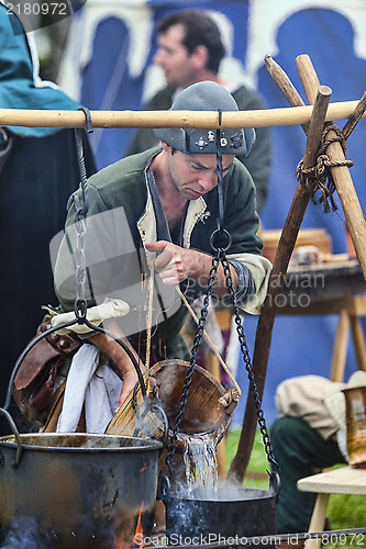 Image of Medieval Man Preparing Food