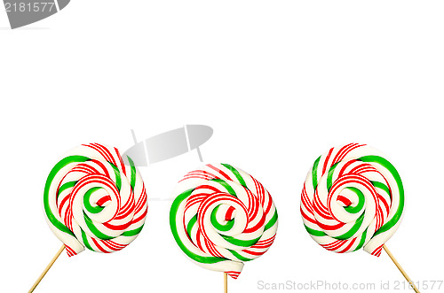 Image of Three sugar lollipops in white green and red isolated on white b