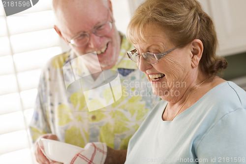 Image of Senior Adult Couple Washing Dishes Together Inside Kitchen