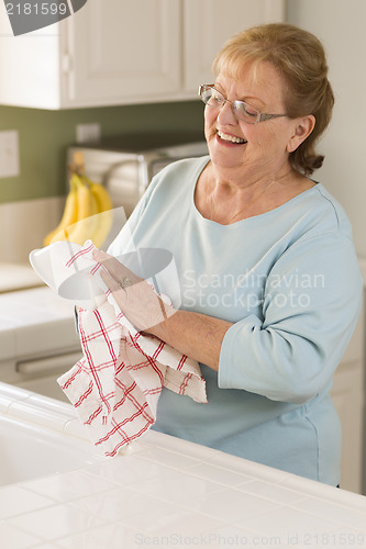Image of Senior Adult Woman Drying Bowl At Sink in Kitchen