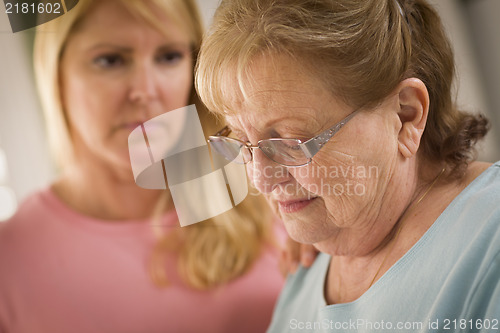 Image of Young Woman Consoles Senior Adult Female