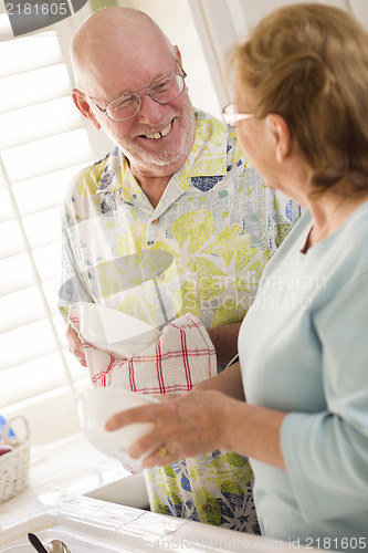 Image of Senior Adult Couple Washing Dishes Together Inside Kitchen