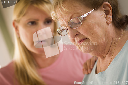 Image of Young Woman Consoles Senior Adult Female