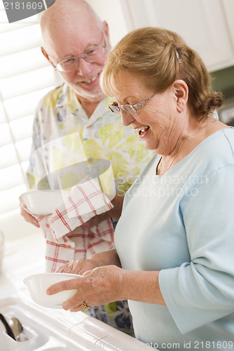 Image of Senior Adult Couple Washing Dishes Together Inside Kitchen