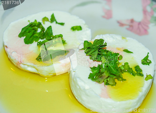 Image of Tomino cheese with rucola and olive oil