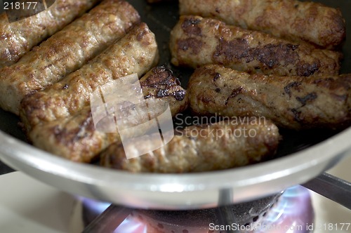Image of cooking sausages in a pan