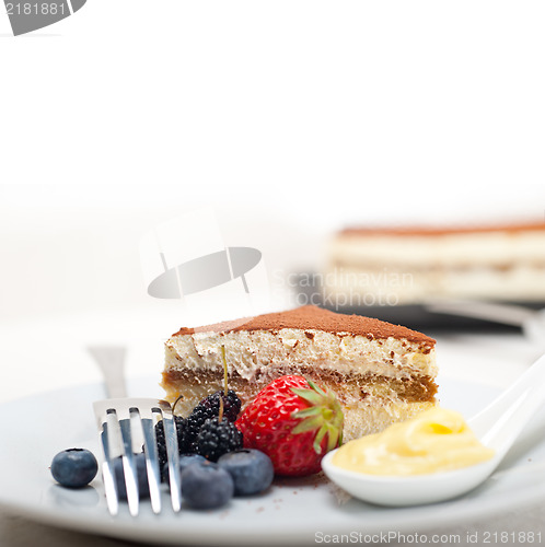 Image of tiramisu dessert with berries and cream